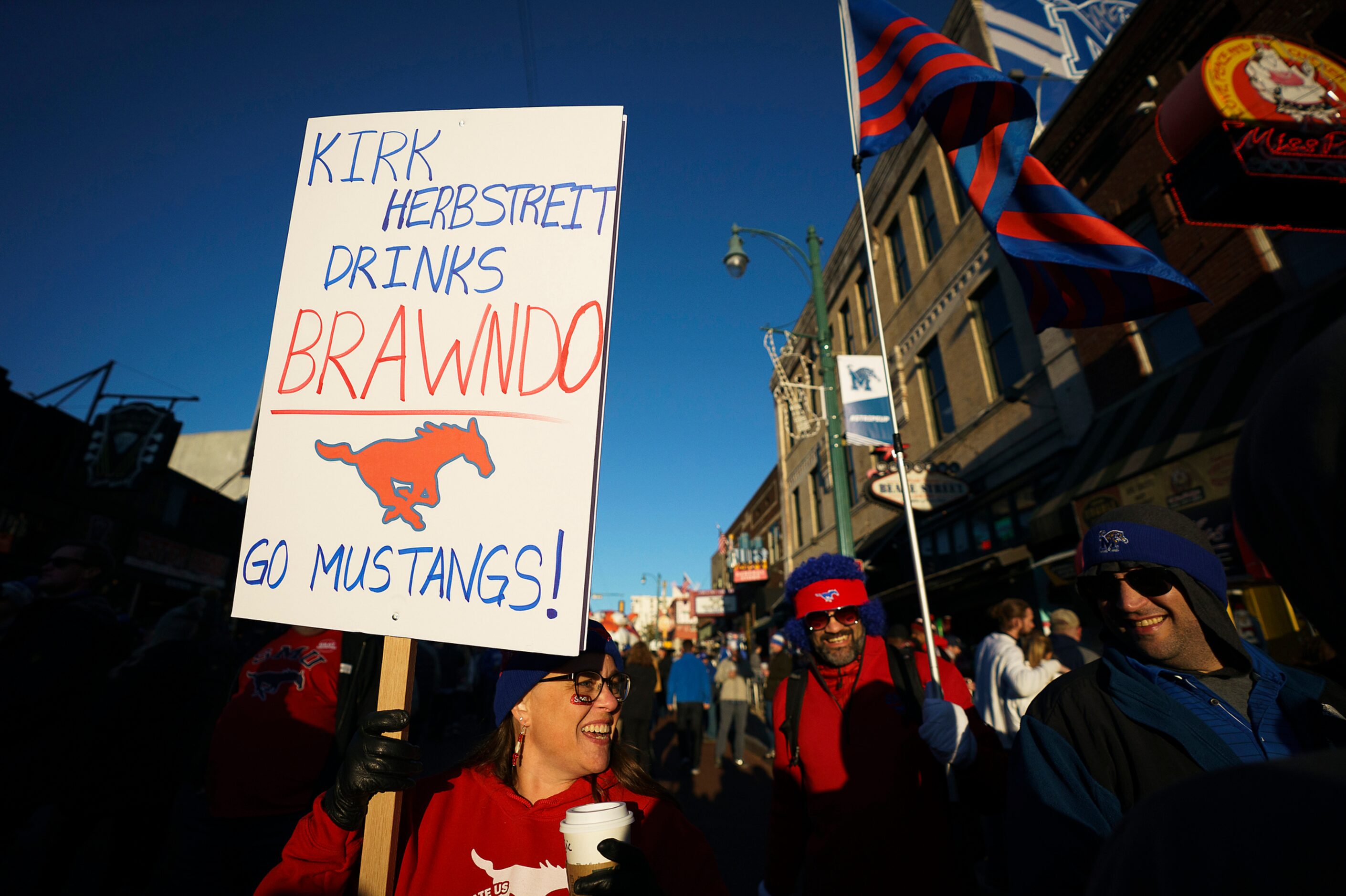 SMU fans Janet (left) and Eric (center) Stephens
walks along Beale Street during ESPN...