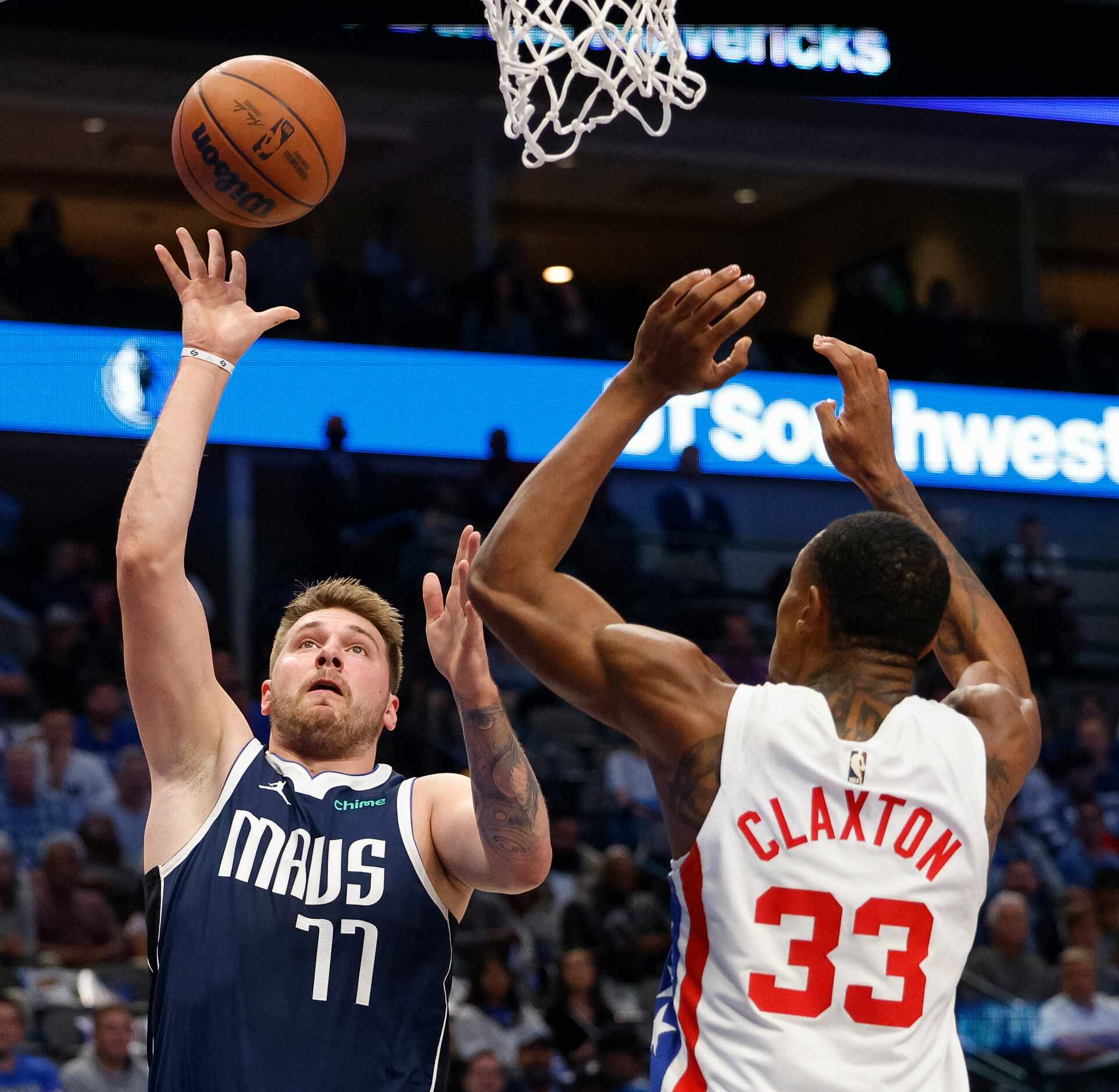 Dallas Mavericks guard Luka Doncic (77) shoots over Brooklyn Nets forward Nic Claxton (33)...