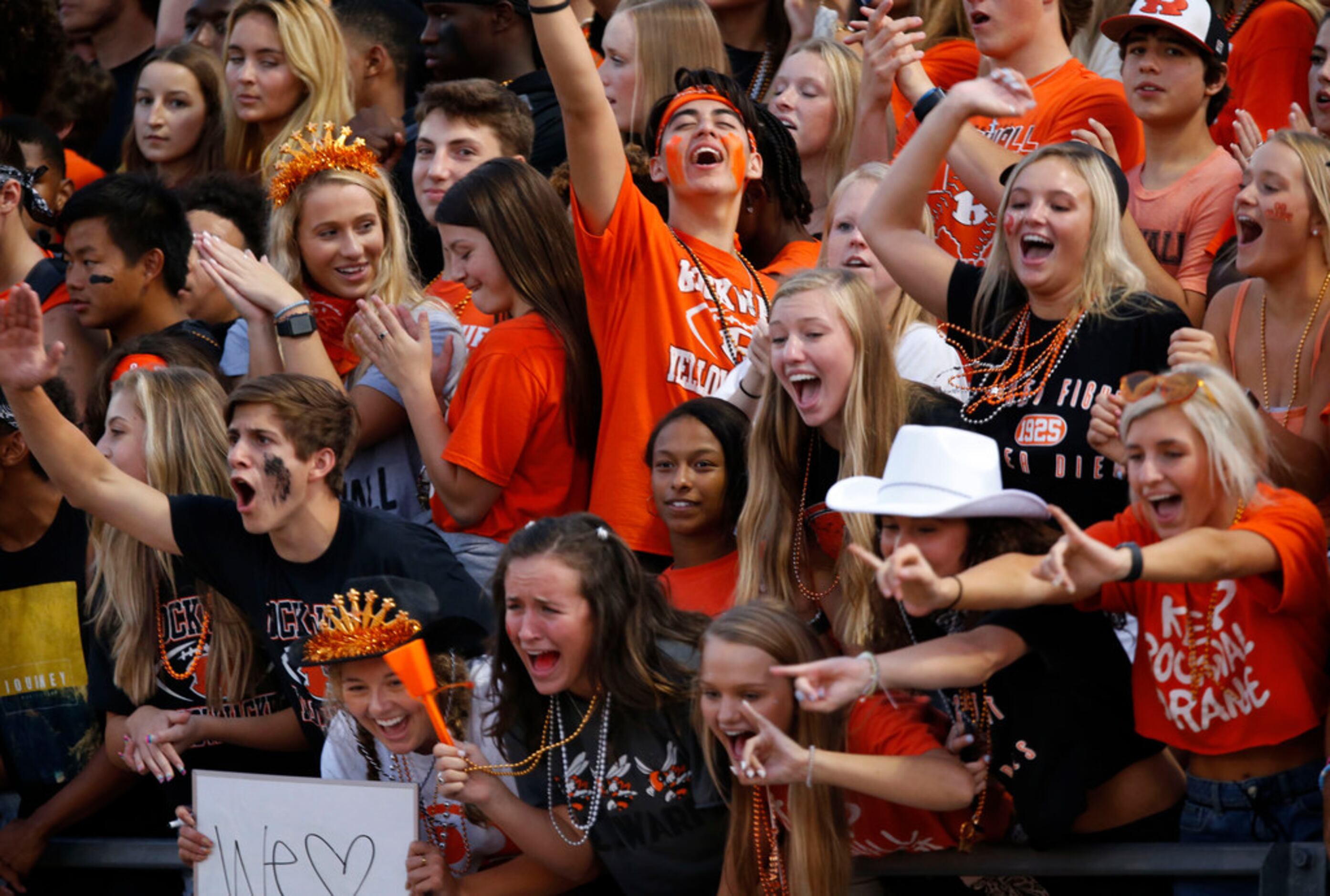 Members of the "Swarm" (Rockwall's student section) cheer on the team during the first half...