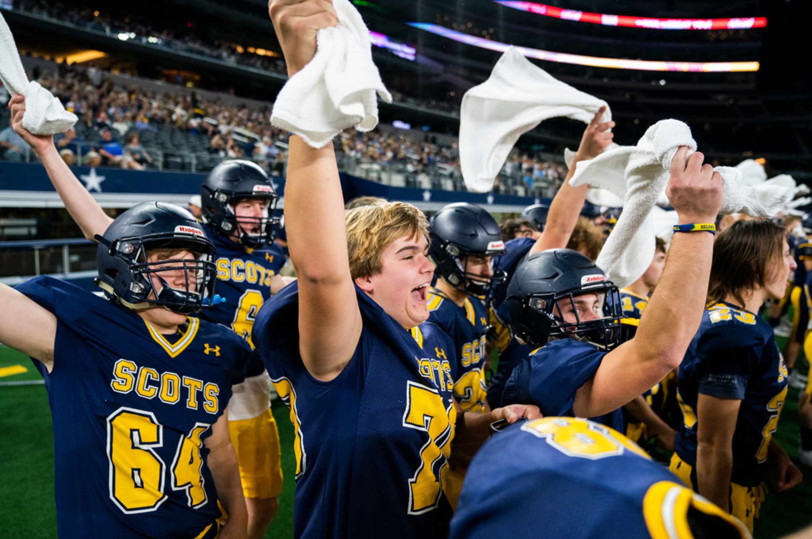 Highland Park football players cheer at a Magnolia third down play during the first quarter...