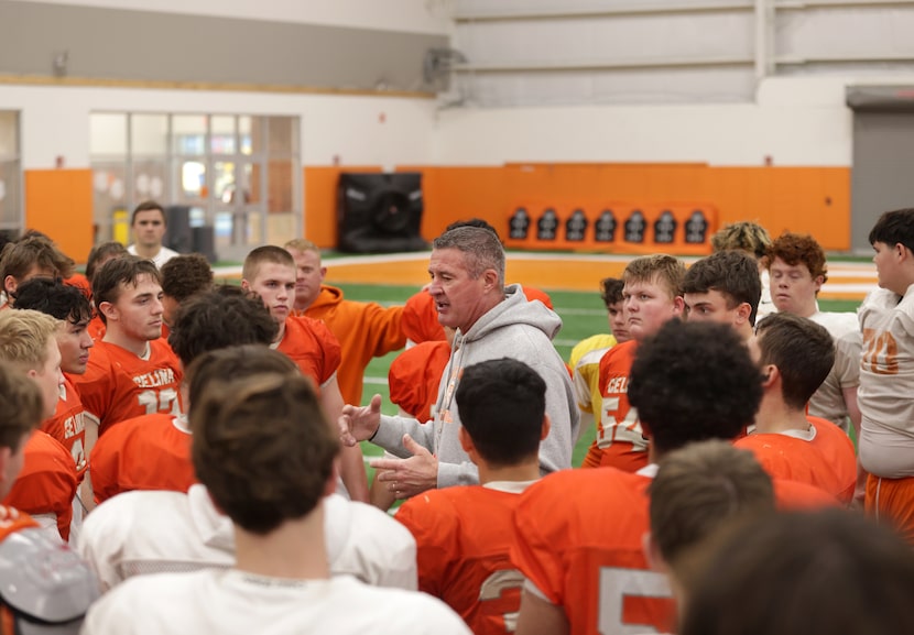 Bill Elliott, center, speaks to the team after morning practice at Celina High School in...