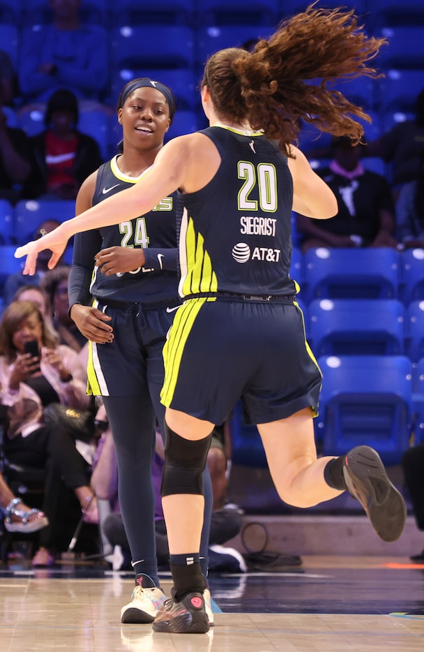 Dallas Wings forward Maddy Siegrist (20) sprints across the court to be the first to...