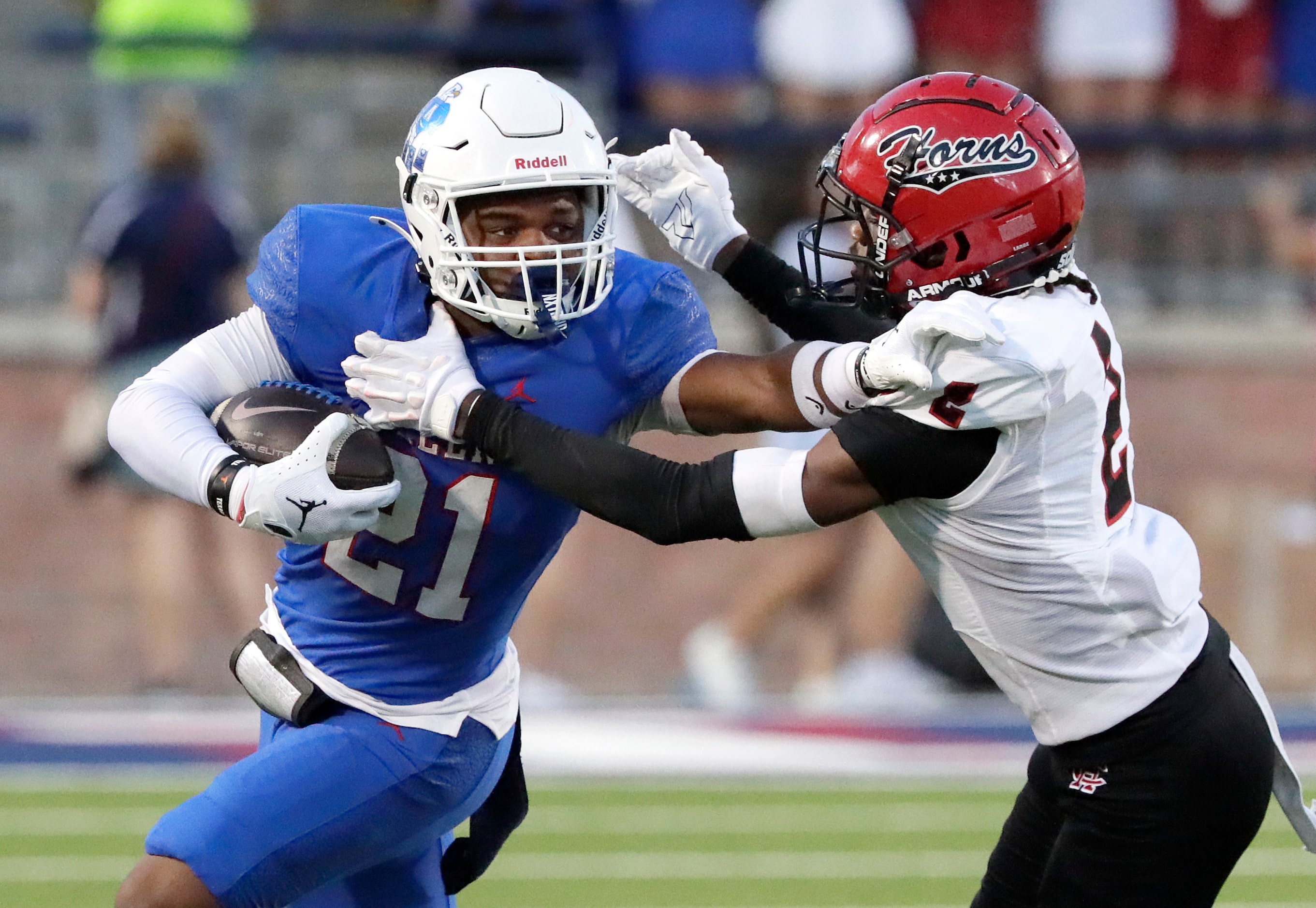 Allen High School running back Jaden Hambric (21) stiff arms Cedar Hill High School...