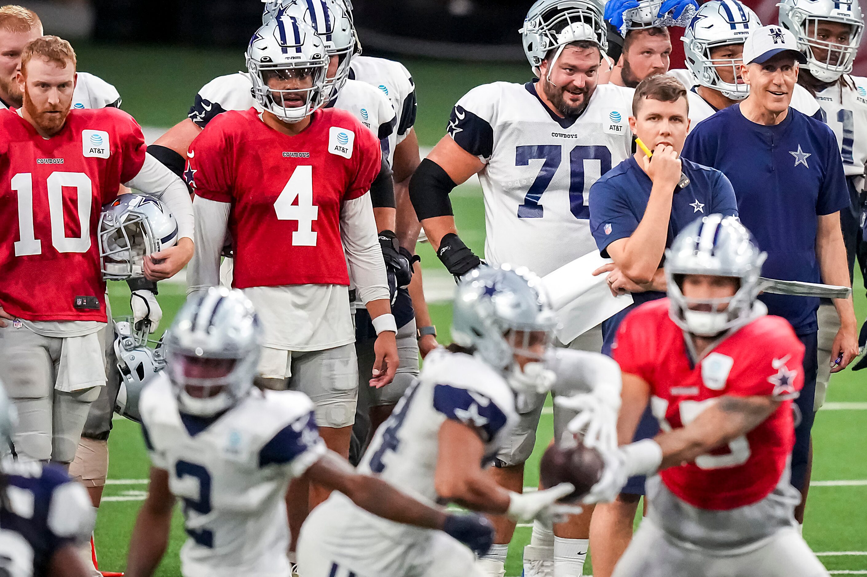 Dallas Cowboys offensive coordinator Kellen Moore watches quarterback Will Grier (15) hand...