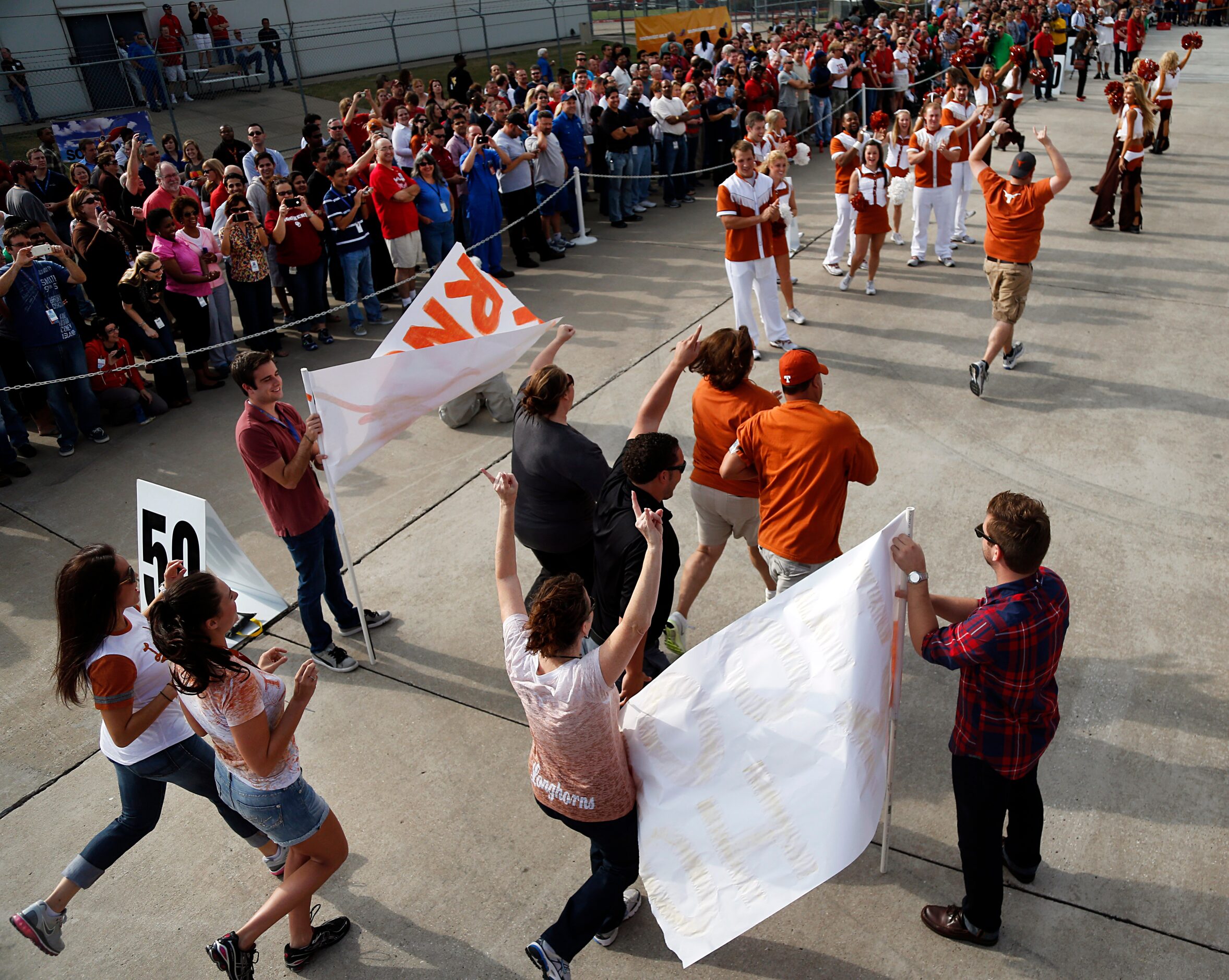 Southwest Airlines employees representing the University of Texas run through the team...