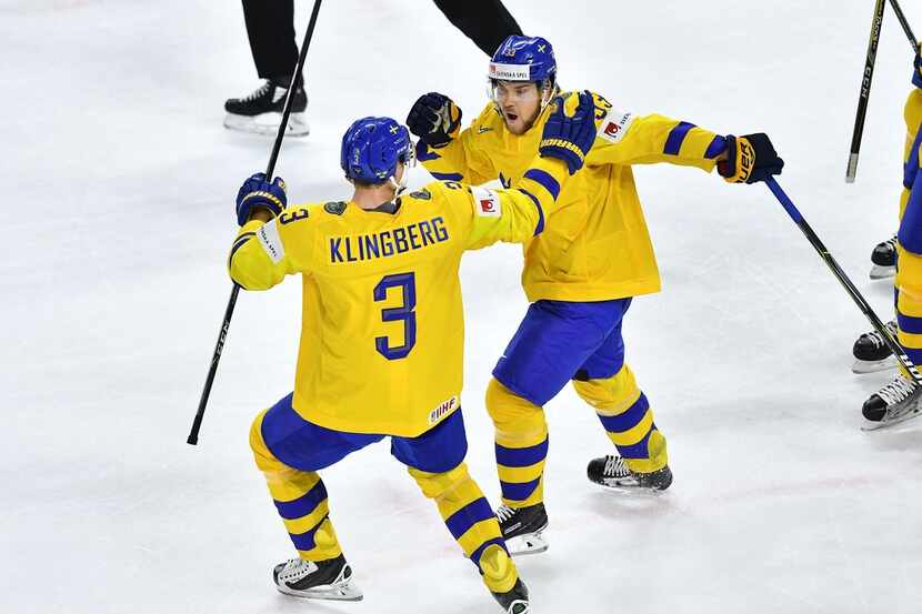 Sweden's Viktor Arvidsson (R) celebrates with teammate Sweden's John Klingberg after scoring...