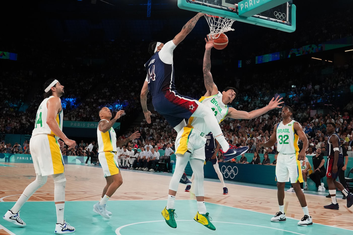 Anthony Davis (14) of the United States dunks over Gui Santos (11) of Brazil during a men’s...