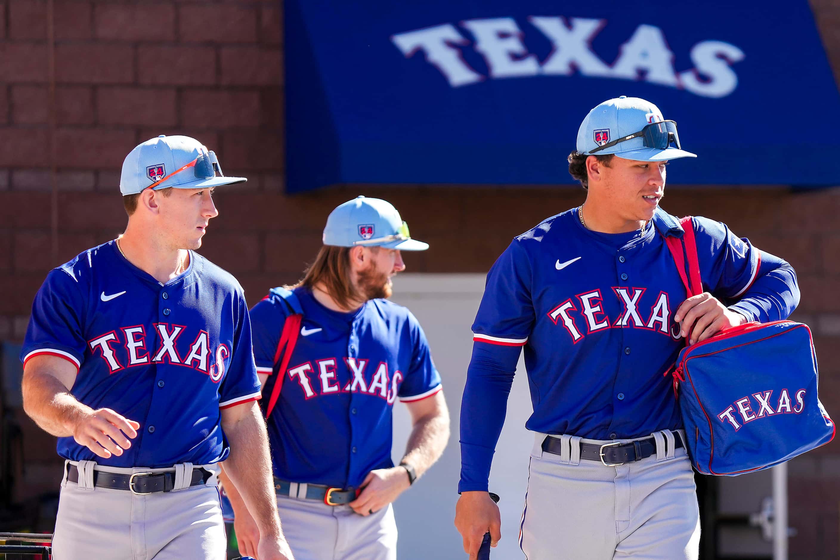 Texas Rangers outfielder Dustin Harris (right), outfielder Wyatt Langford (left) and...