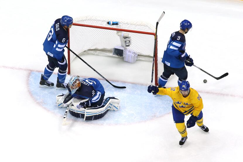 SOCHI, RUSSIA - FEBRUARY 21:  Daniel Sedin #22 of Sweden celebrates a second-period goal by...