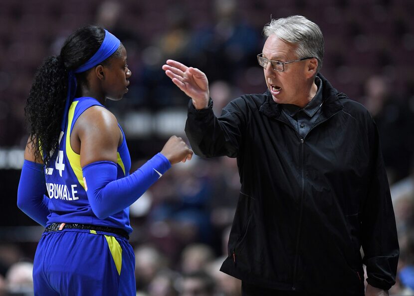 Dallas Wings head coach Brian Agler, right, talks with Dallas Wings' Arike Ogunbowale during...