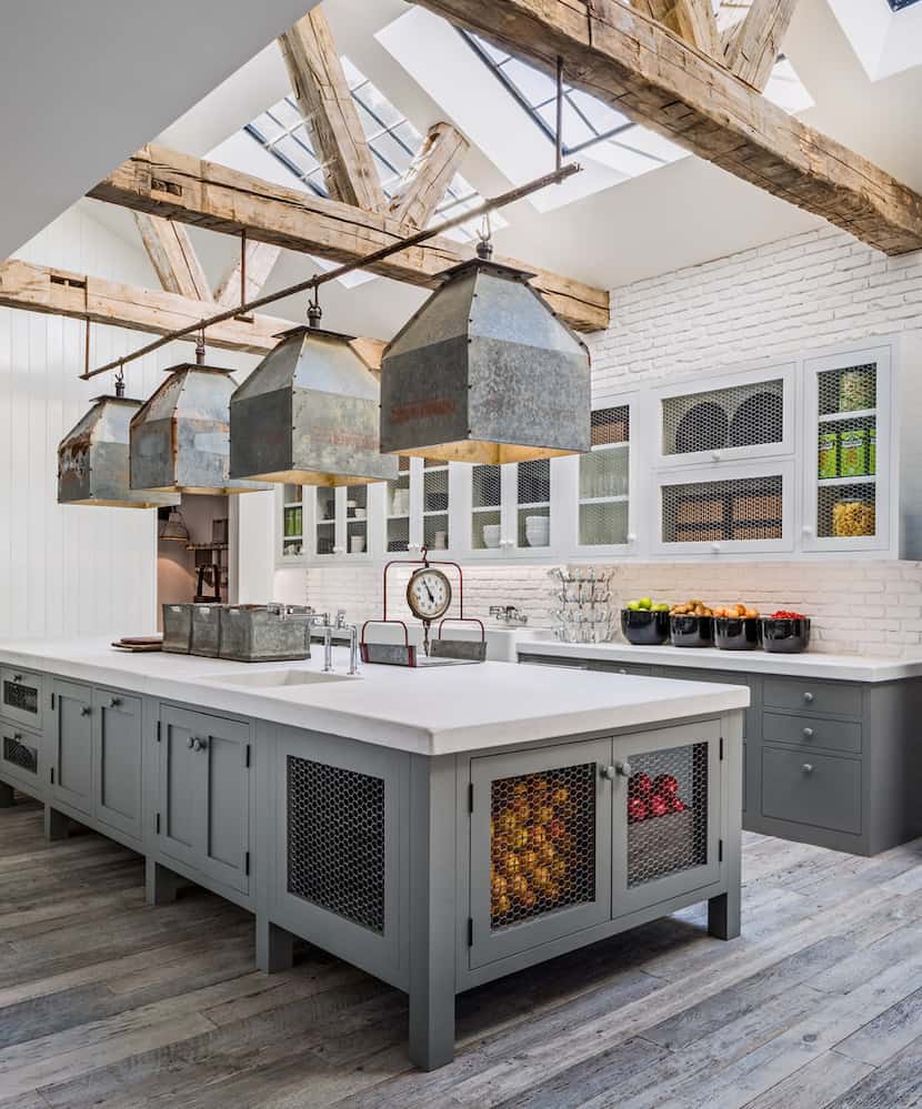 Skylights flood Keaton's kitchen with light. Cabinets in a cool gray and white palette are...