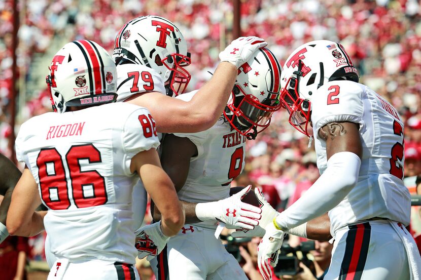 NORMAN, OK - SEPTEMBER 28:  Wide receiver T.J. Vasher #9 is congratulated after scoring a...