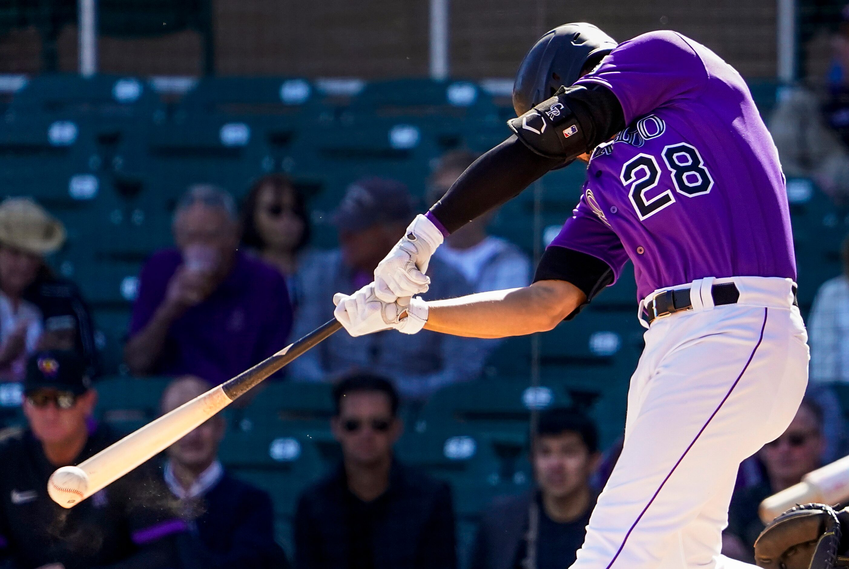 Colorado Rockies third baseman Nolan Arenado bats during the third inning of a spring...