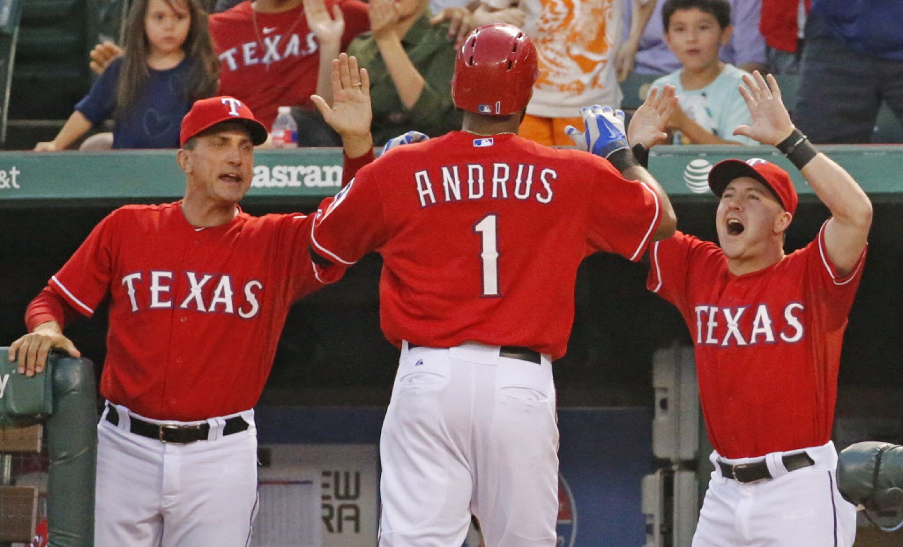 Texas manager Tim Bogar, left, and outfielder Daniel Robertson, right, greet Elvis Andrus at...