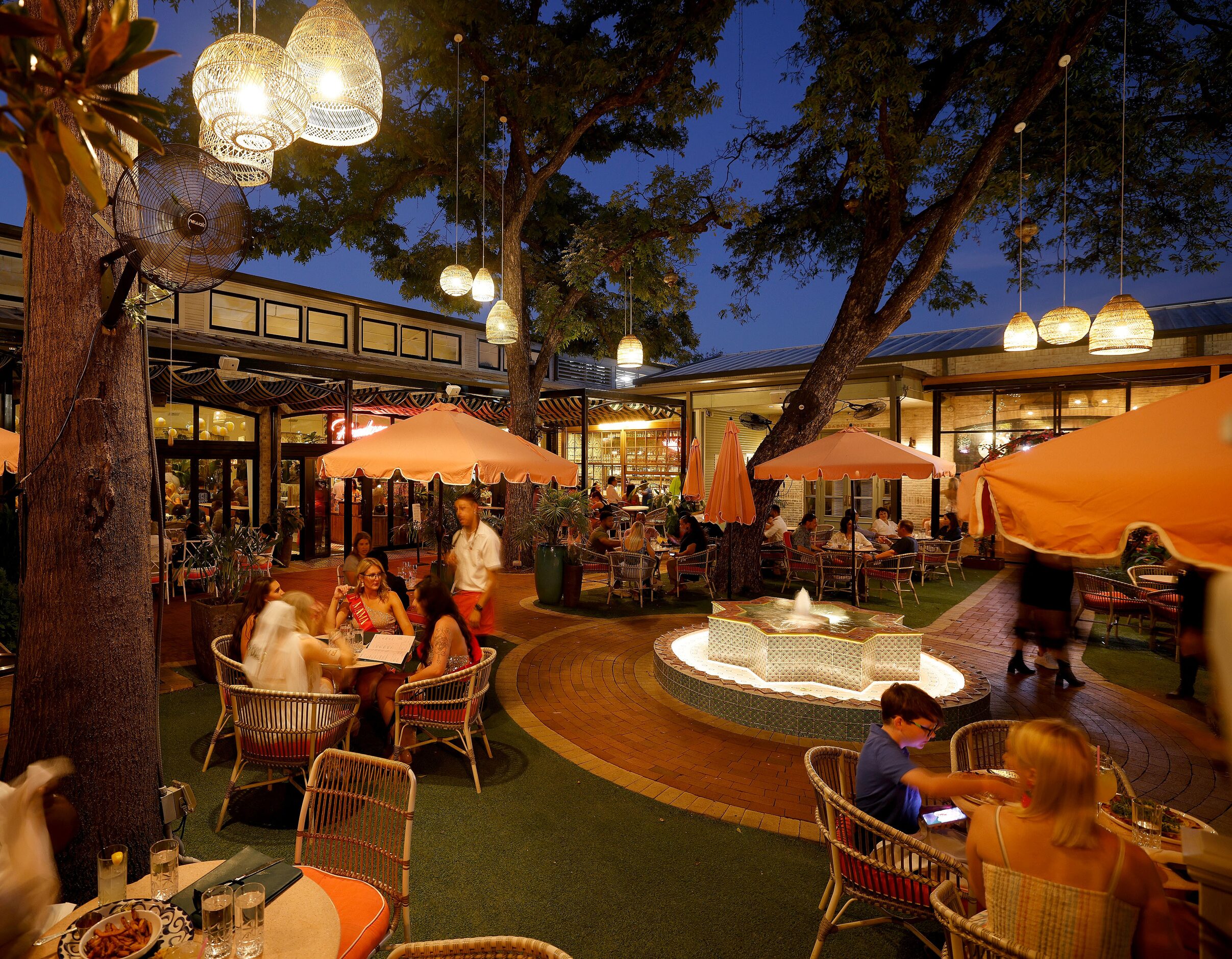 People sit on the patio at Paradiso in the Bishop Arts District in Dallas, Saturday, Sept....