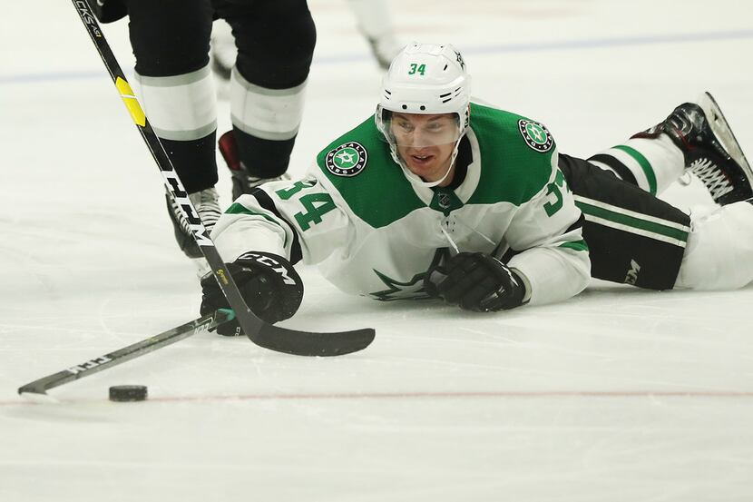 LOS ANGELES, CALIFORNIA - FEBRUARY 28: Denis Gurianov #34 of the Dallas Stars dives for the...