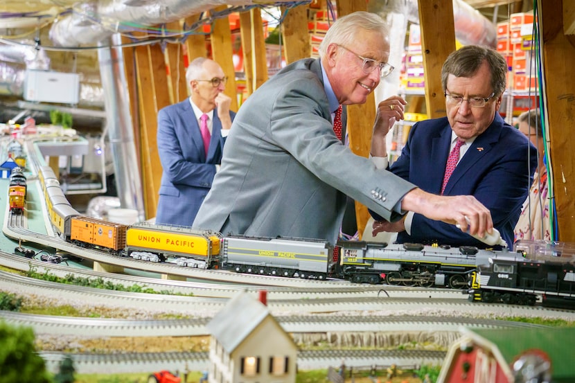 David Miller (center) showed off his attic train set to SMU president R. Gerald Turner on...