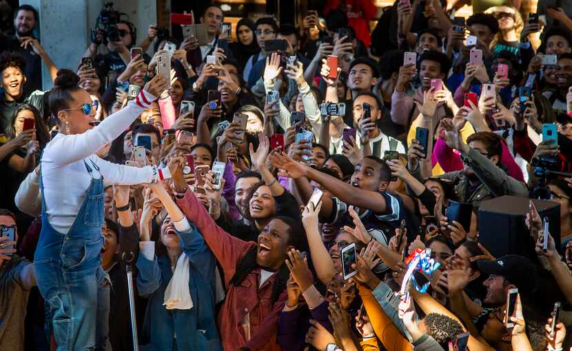 Singer Alicia Keys takes a selfie with the crowd during a youth voter rally at Richland...
