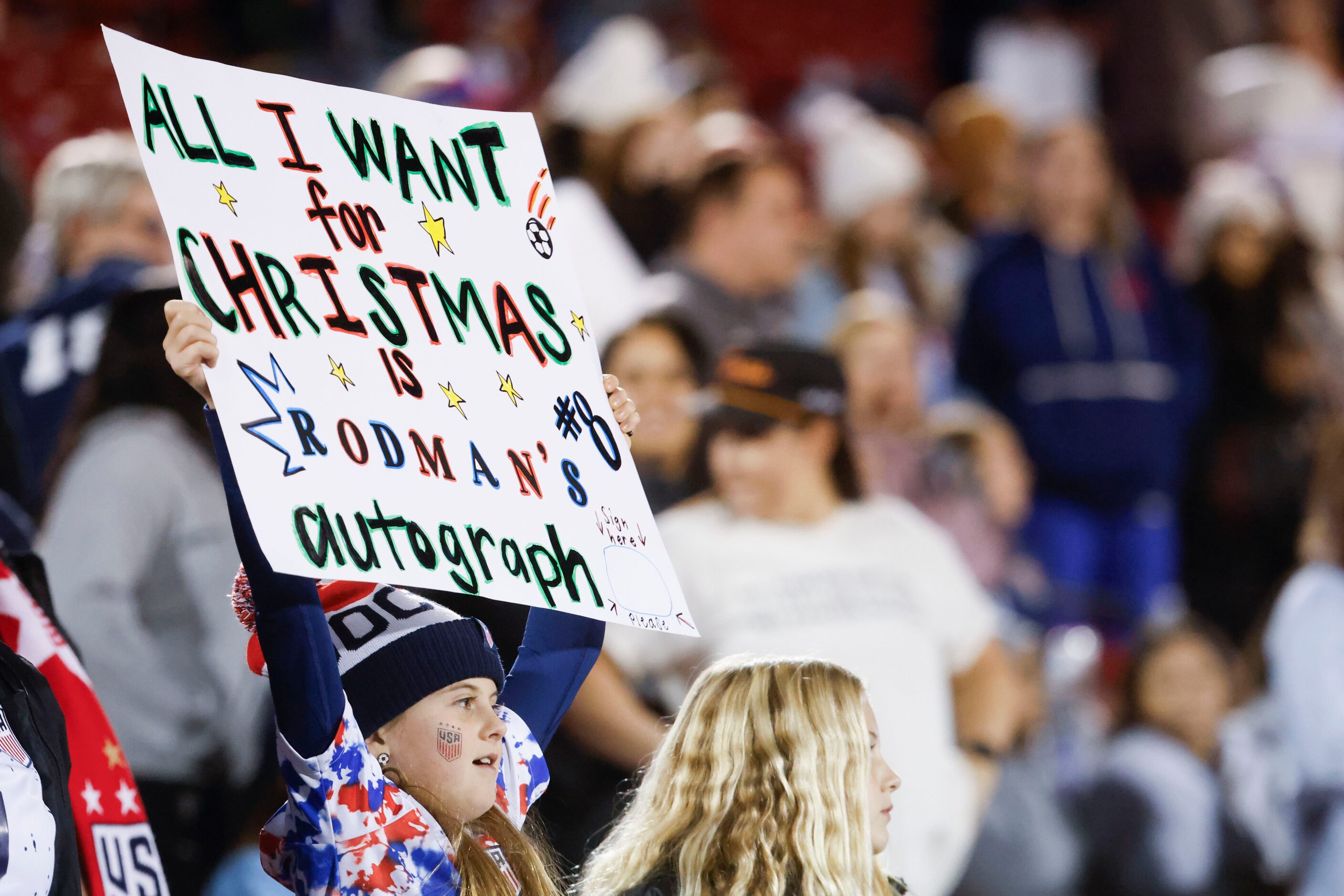 A young fan holds a sign ahead of the first half of a soccer game between United States and...