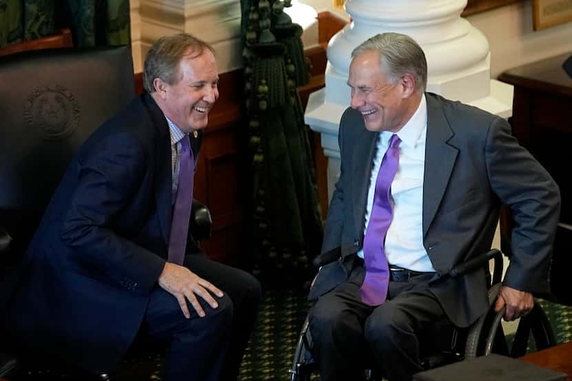 FILE - Texas Attorney General Ken Paxton, left, and Gov. Greg Abbott talk during on the...