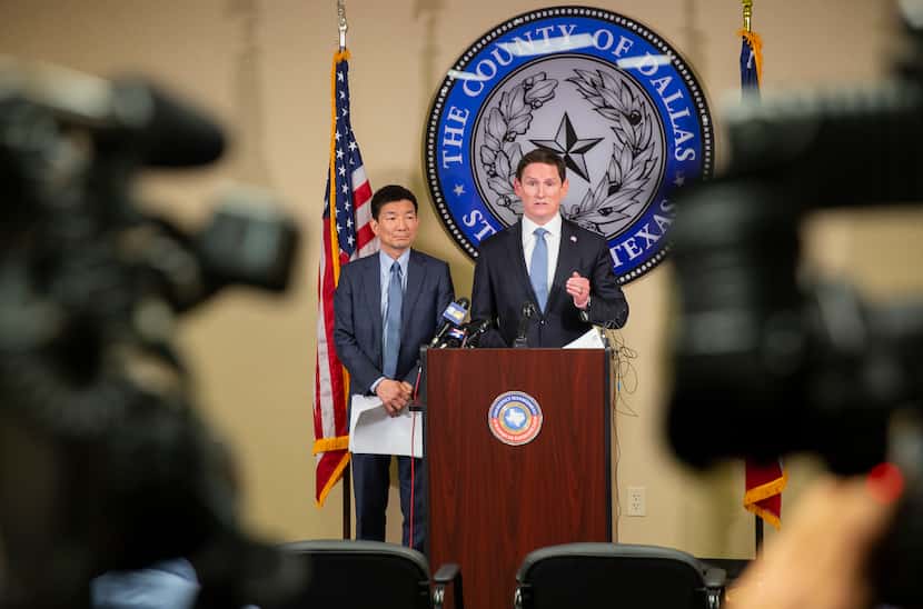 Dallas County Judge Clay Jenkins (right) and Dr. Philip Huang, director of Dallas County...