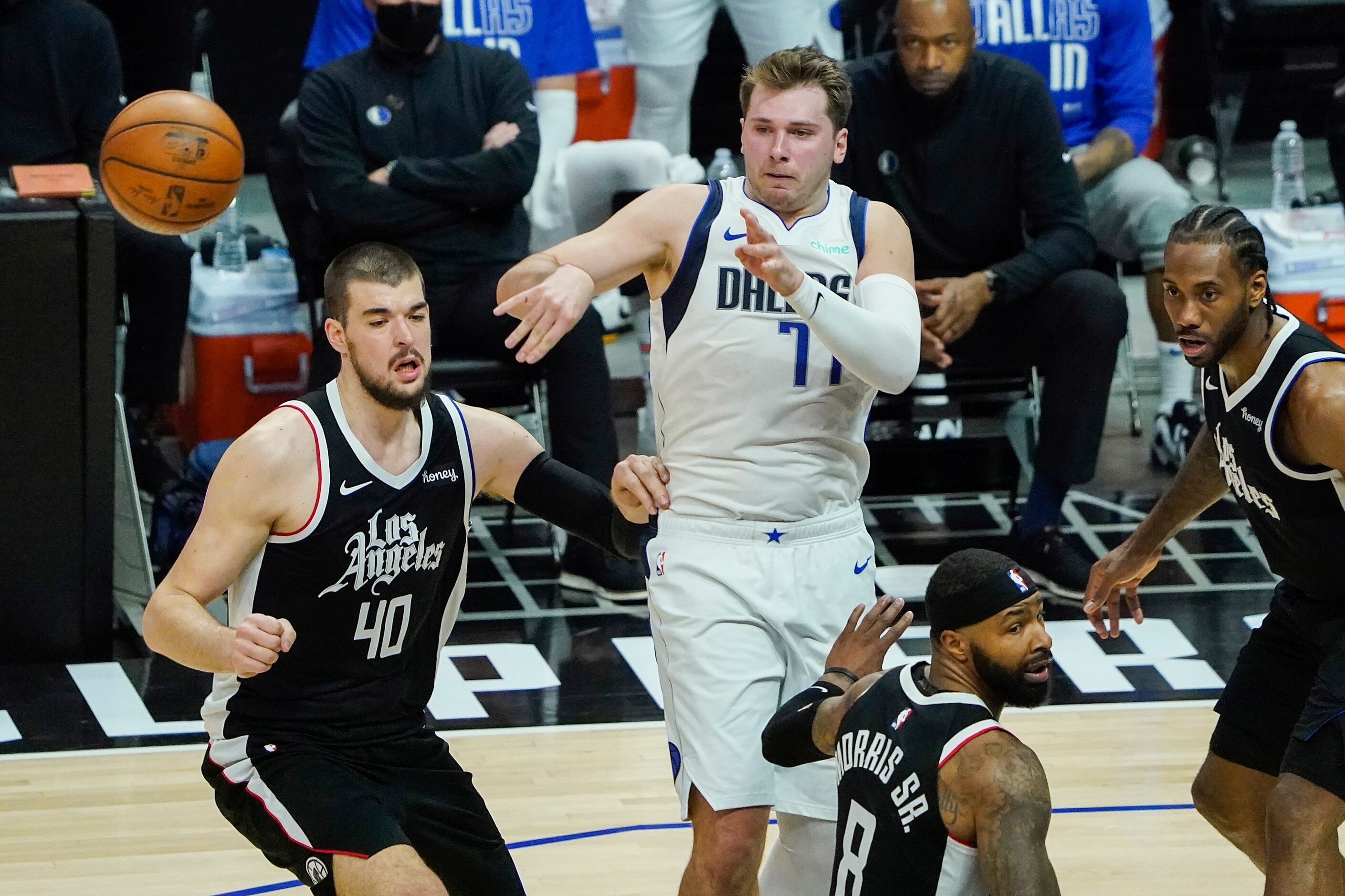 Dallas Mavericks guard Luka Doncic (77) passes the ball under pressure from LA Clippers...