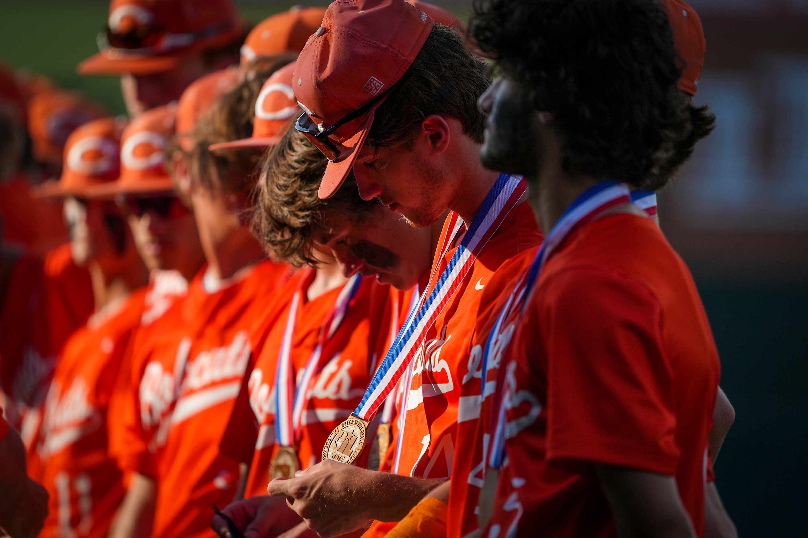 Celina pitcher Cole Marthiljohni looks at his state semifinalist medal after a loss to...