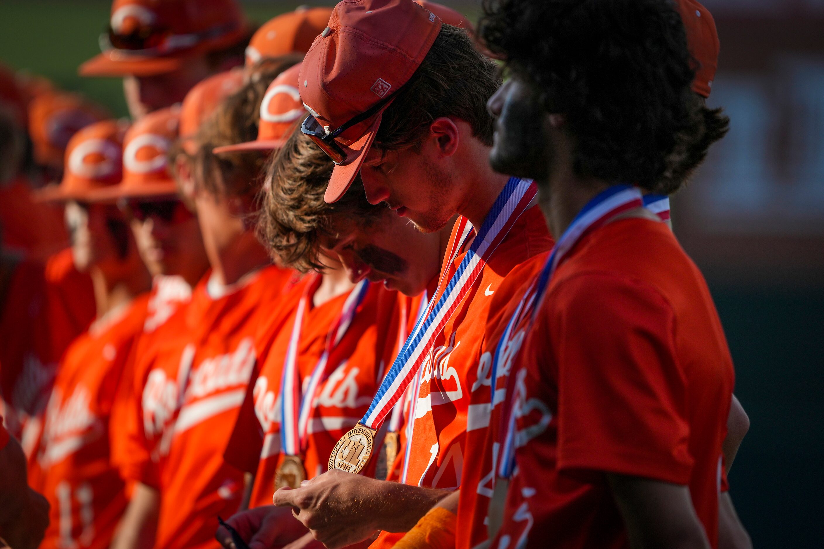 Celina pitcher Cole Marthiljohni looks at his state semifinalist medal after a loss to...