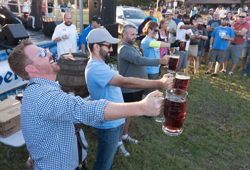 Contestants compete in a stein holding contest during the 2017 Oktoberfest Dallas. The 2021...