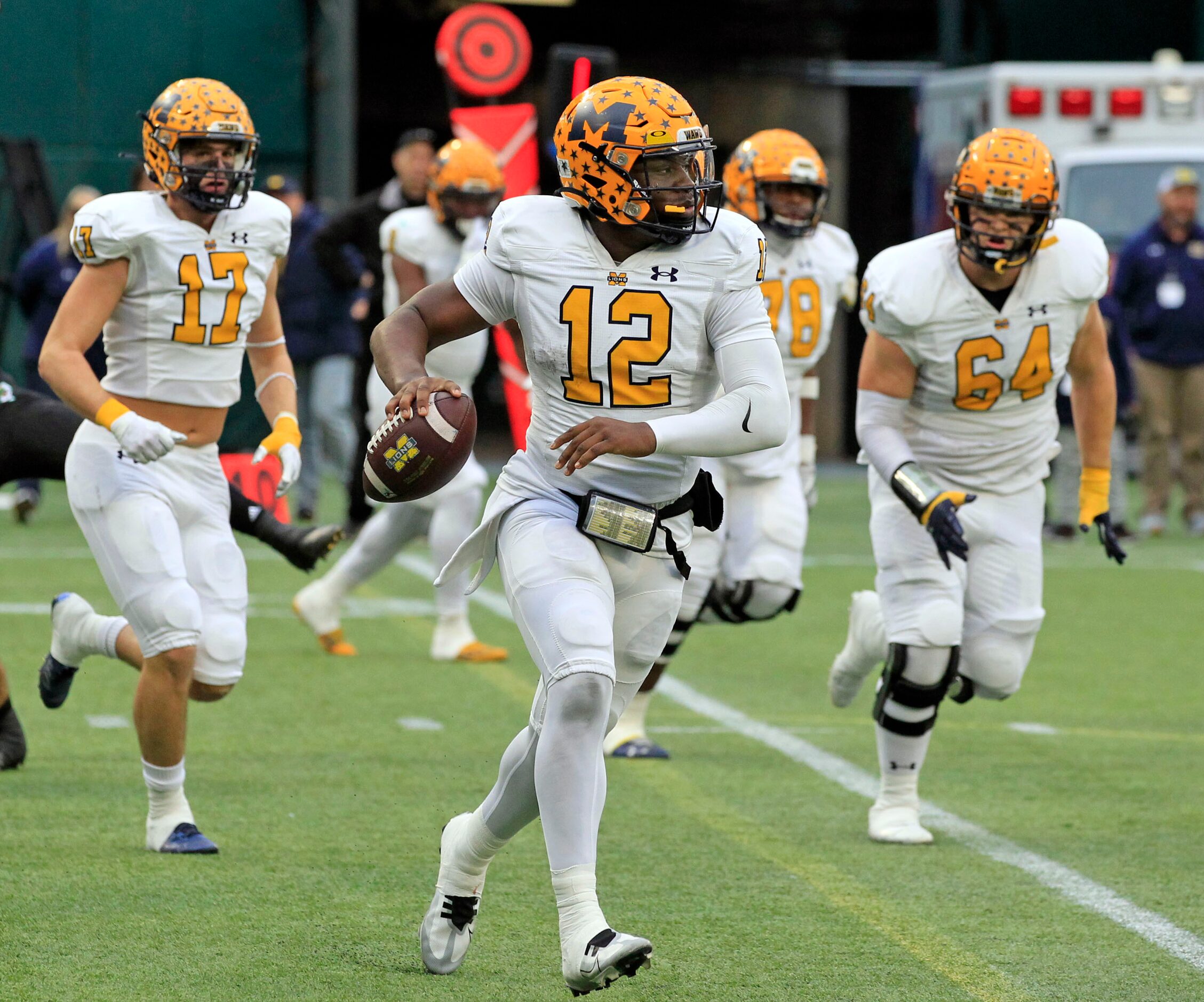 McKinney High QB Keldric Luster (12) scrambles around right end during the first half of the...