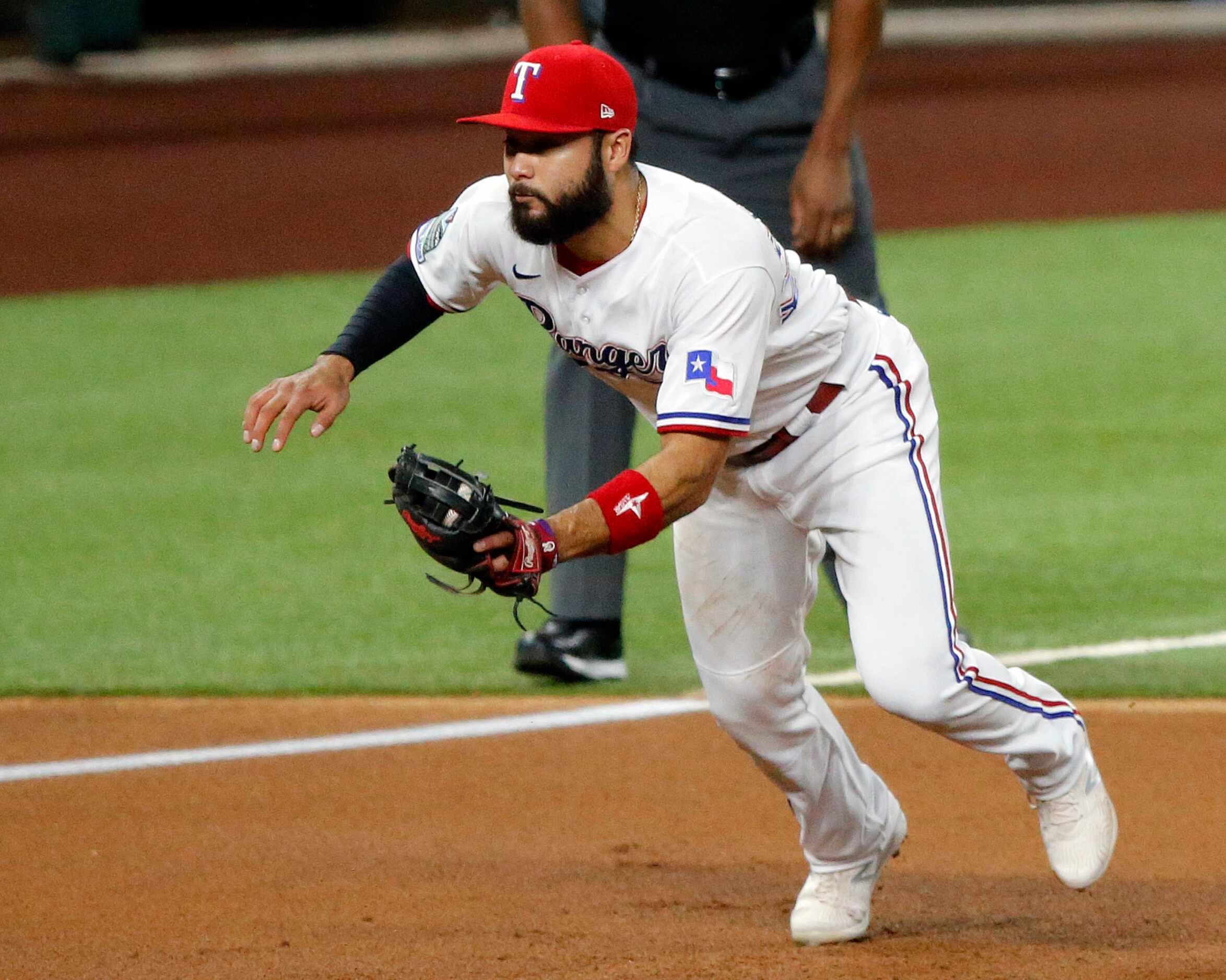 Texas Rangers third baseman Isiah Kiner-Falefa (9) fields a ball hit by Seattle Mariners...