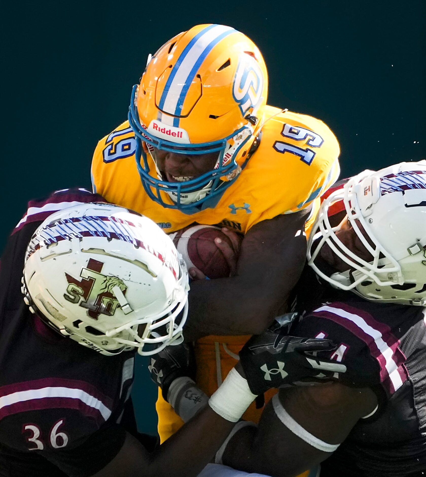 Southern running back Karl Ligon (19) is stopped by TSU safety Charles George Jr. (36) and...