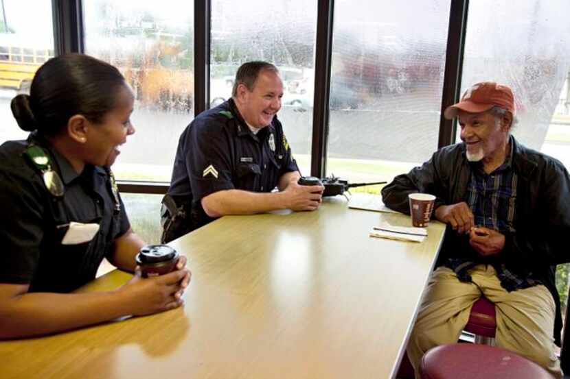 
Dallas Police Department officer L.R. Kelly and Sr. Cpl. J.J. Ehlinger talk with Lloyd...