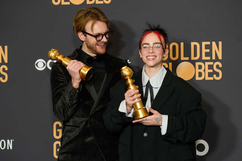 Finneas, left, and Billie Eilish pose in the press room with the award for best original...