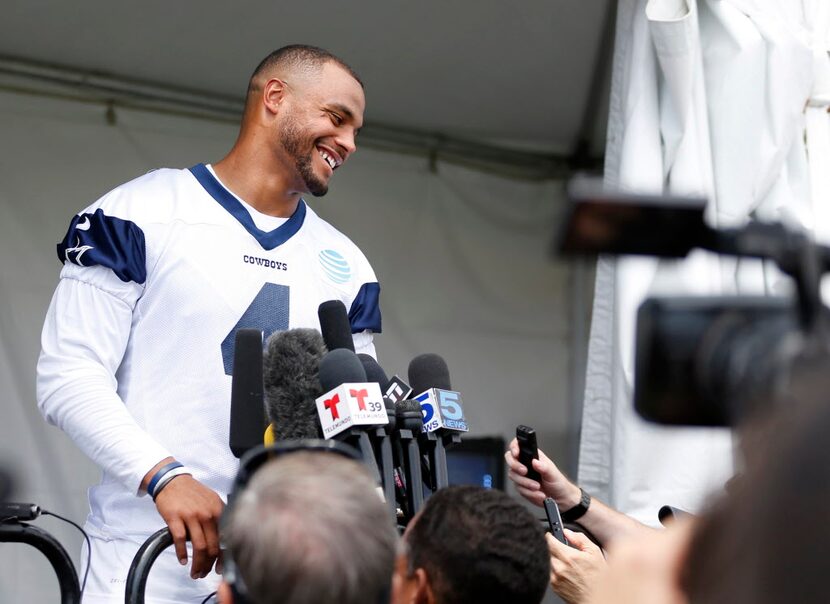 Dallas Cowboys quarterback Dak Prescott (4) laughs after a question as he answers questions...