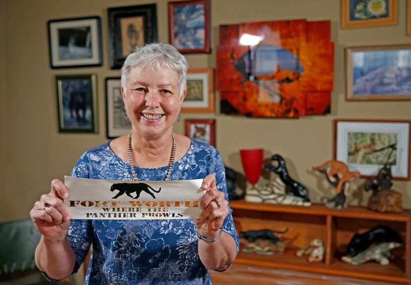Tarrant County historian Carol Roark poses with collector Larry Schuessler's Panther City...