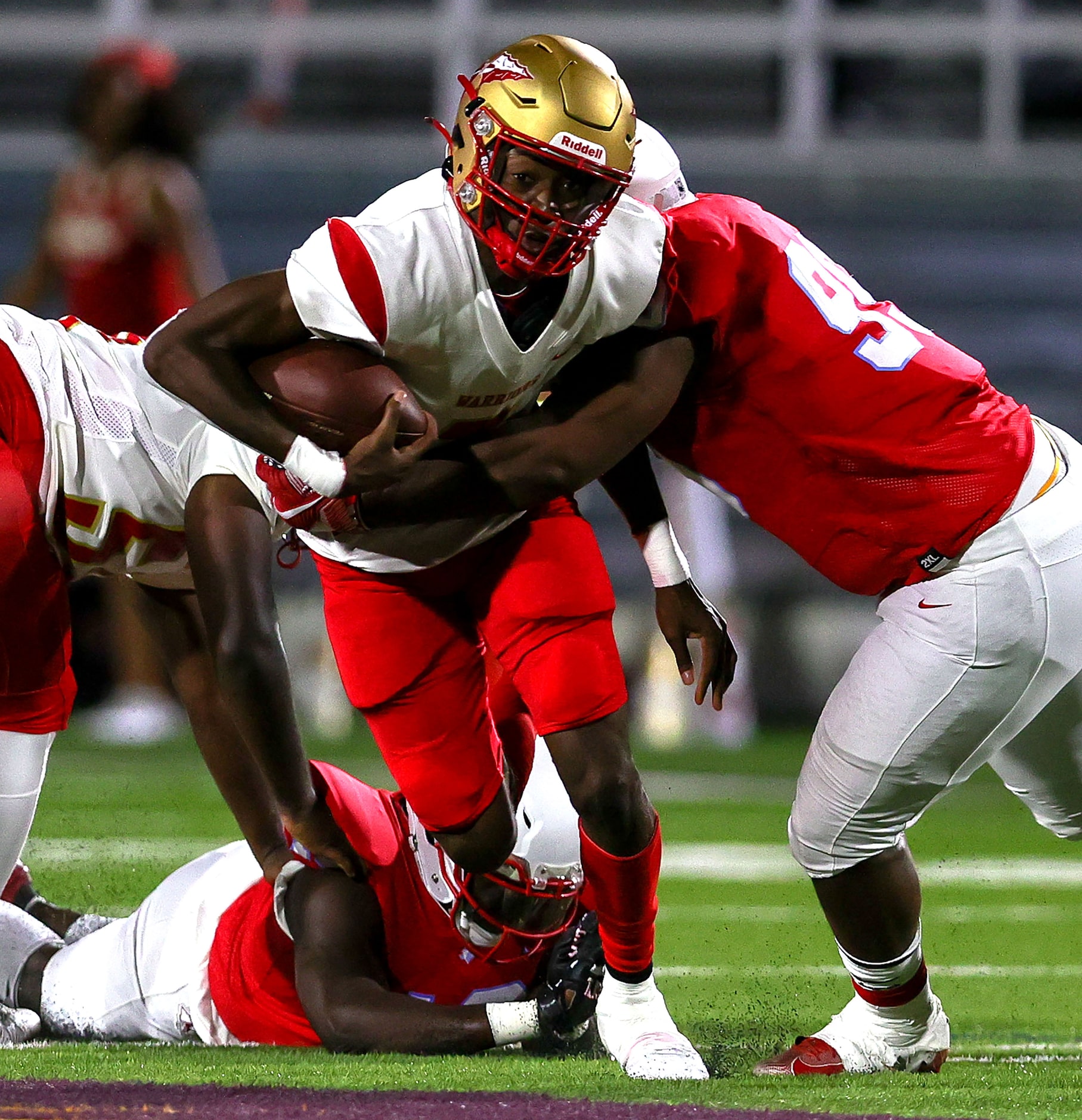 South Grand Prairie quarterback Michael Stallworth (C) tries to get break free from Skyline...