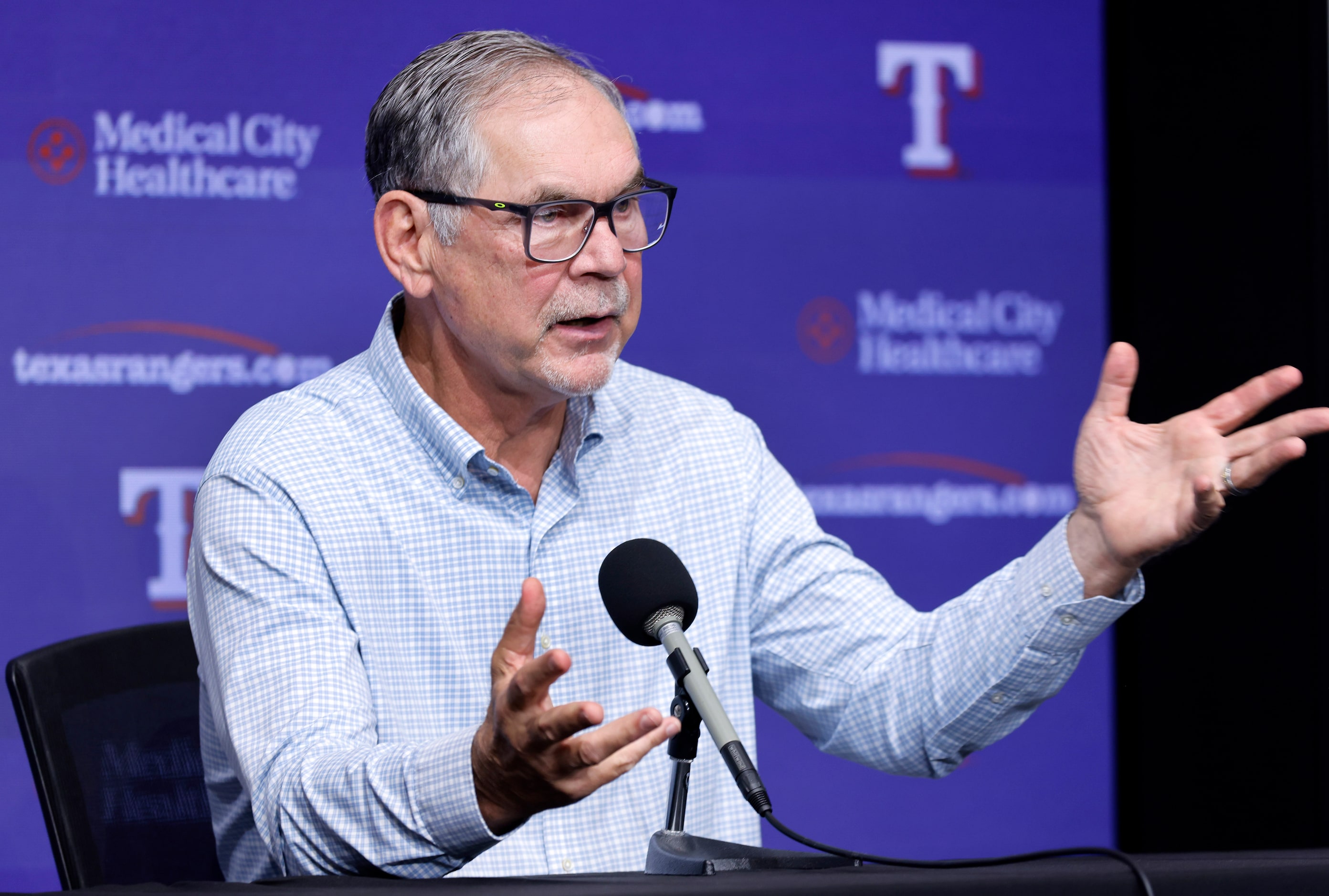 Texas Rangers manager Bruce Bochy responds to a question from reporters during a post season...