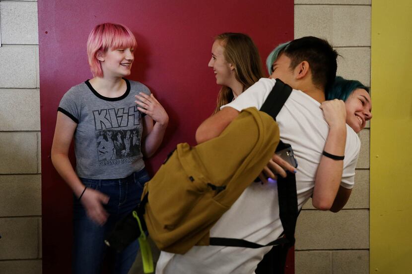 Miriam Priesman (left) and Mila Fisher, both sophomore students, talk in the hallway while...