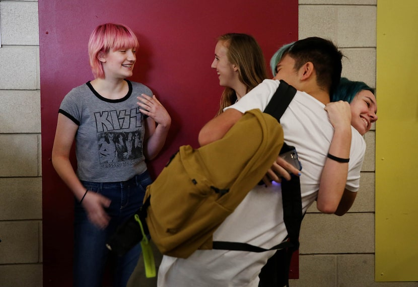 Miriam Priesman (left) and Mila Fisher, both sophomore students, talk in the hallway while...