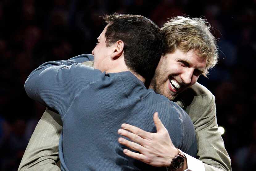 Dallas Mavericks' Dirk Nowitzki hugs team owner Mark Cuban, front, during an NBA...