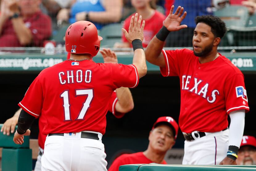 Texas Rangers' Shin-Soo Choo (17) celebrates his run scored with teammate Elvis Andrus on a...