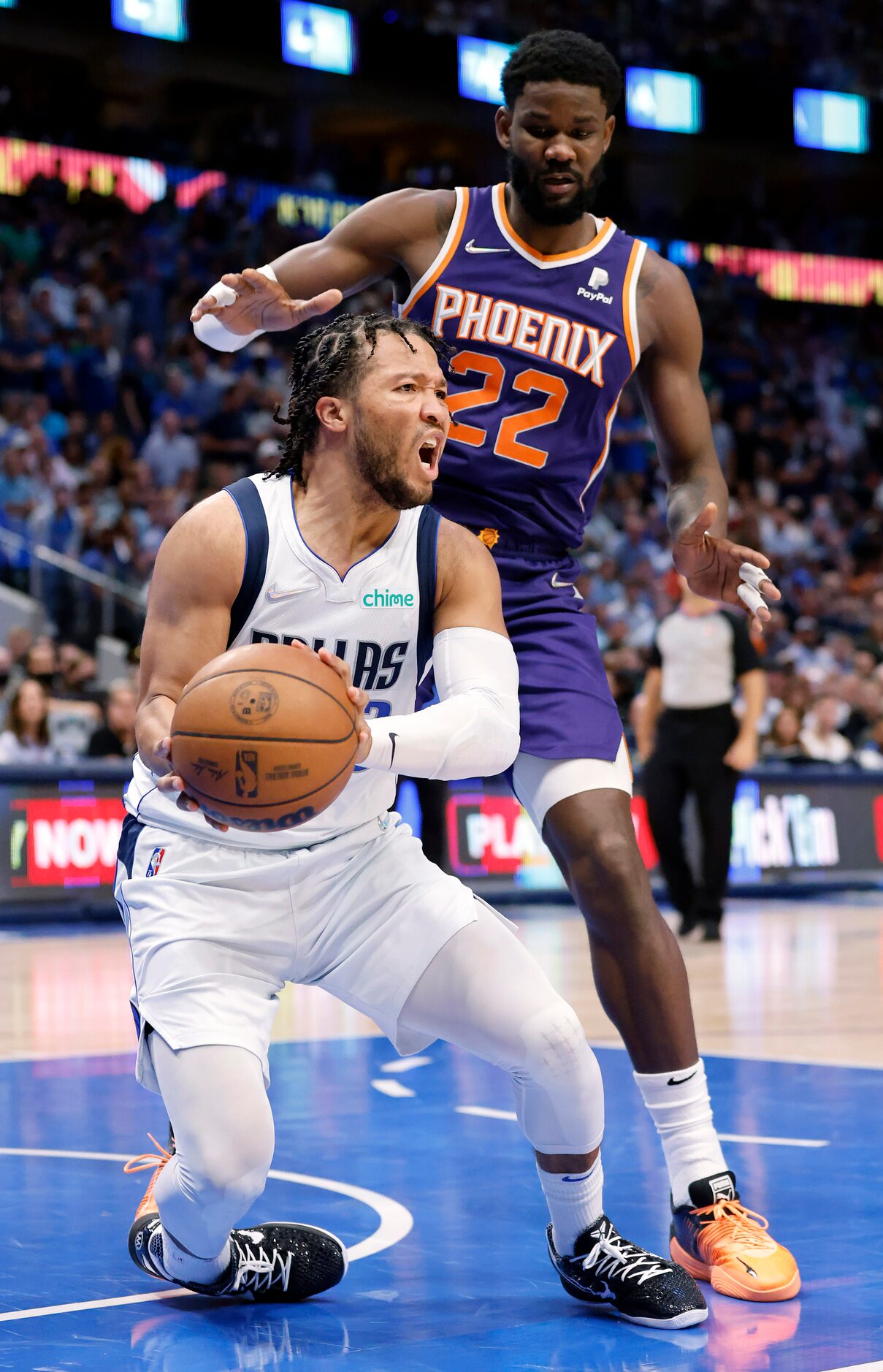 Dallas Mavericks guard Jalen Brunson (13) reacts a he rolls his ankle looking pass from...