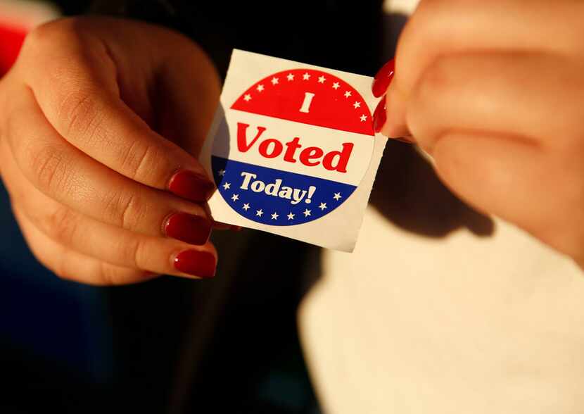 Maria Garcia, a first-time voter, holds an "I Voted Today!" sticker after casting her ballot...
