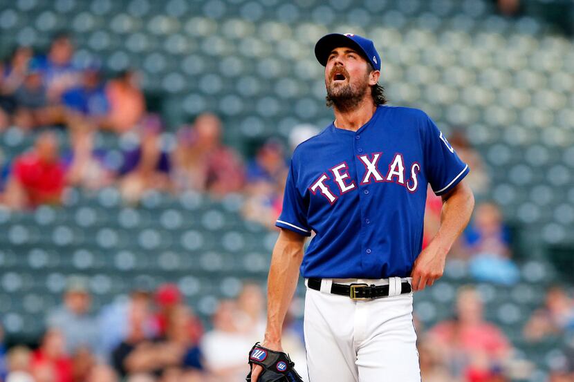 Texas Rangers starting pitcher Cole Hamels (35) takes a moment on the mound as he gets off...