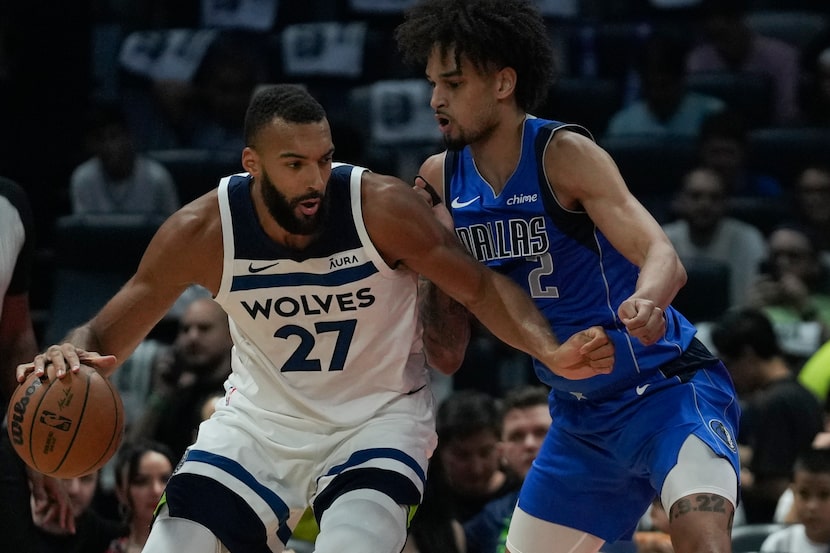 Rudy Gobert of Minnesota Timberwolves is guarded by Dereck Lively of Dallas Mavericks during...