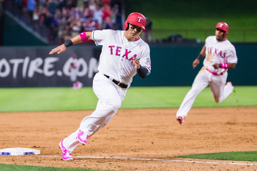 Shin-Soo Choo (17) and shortstop Elvis Andrus (1) round the bases after a hit by right...