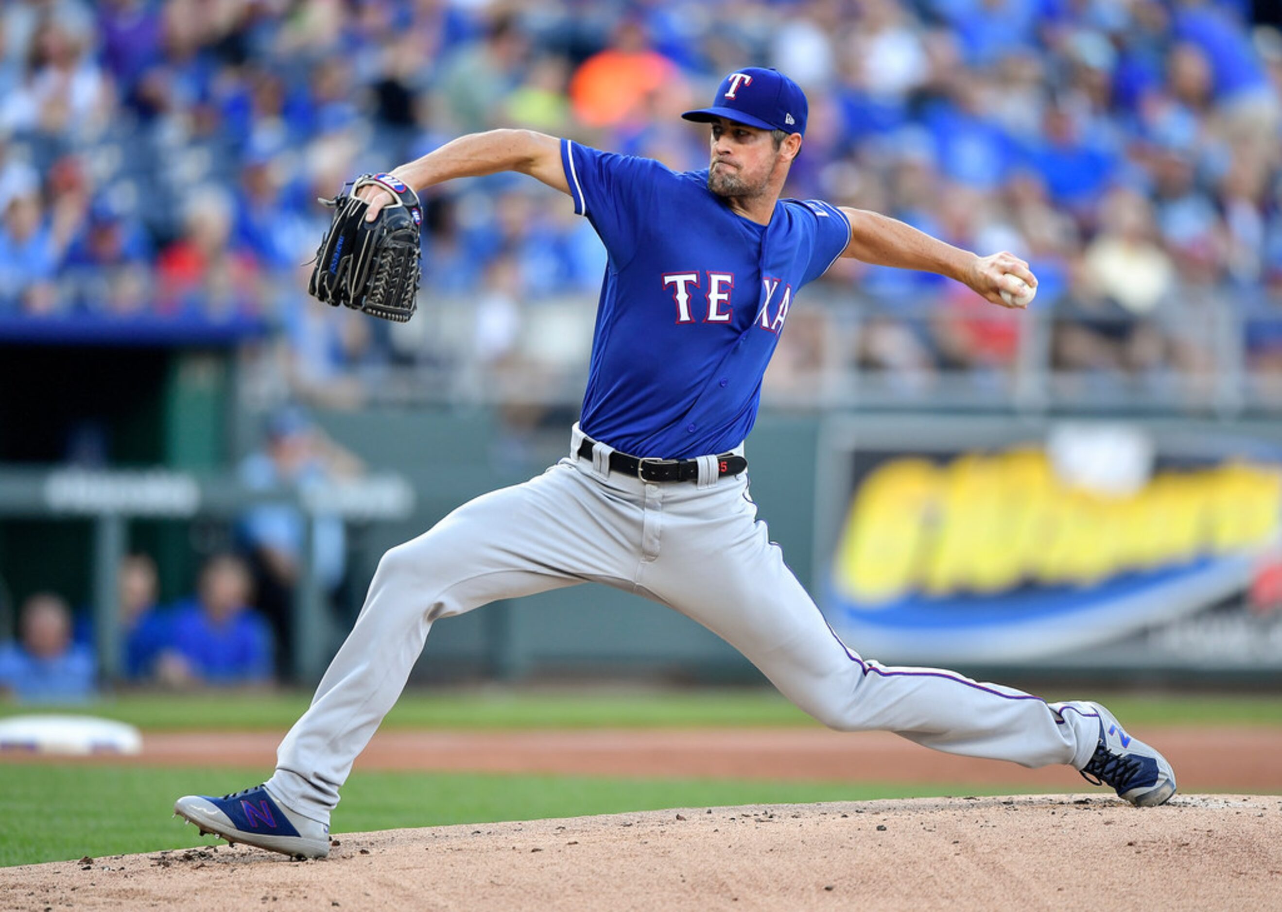 Texas Rangers starting pitcher Cole Hamels throws in the first inning against the Kansas...