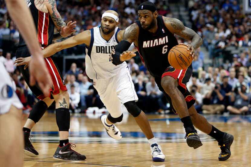 Miami Heat small forward LeBron James (6) drives past Dallas Mavericks shooting guard Vince...