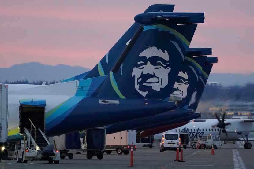 FILE - Alaska Airlines planes are shown parked at gates at sunrise, March 1, 2021, at...